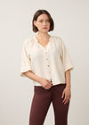 Front view of cream blouse with colorful buttons and V-neck by French Dressing Jeans (FDJ)