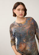 Close-up of earthy-toned Henley top emphasizing round neckline and pattern by French Dressing Jeans (FDJ)