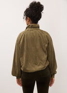 Back view of olive jacket highlighting relaxed fit and texture by French Dressing Jeans (FDJ)