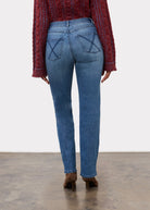 Back view of indigo jeans highlighting patch pockets and mid-rise waist by French Dressing Jeans (FDJ)