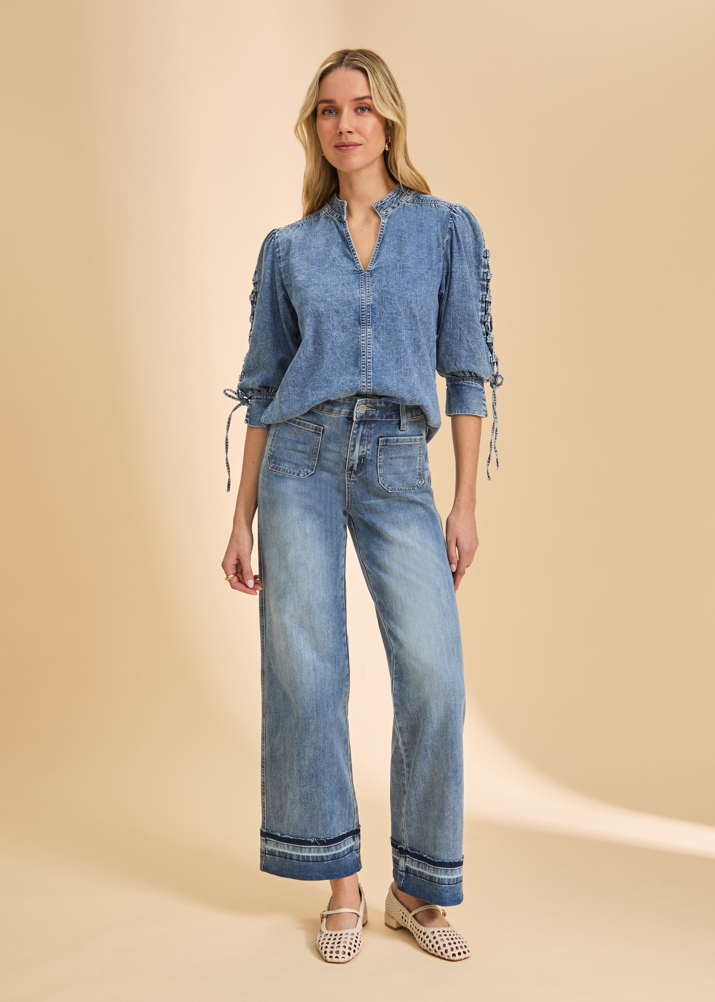 Model in wide-leg denim with cuffed hem and patch pockets by French Dressing Jeans (FDJ)