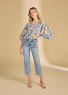 Model in floral embroidered ocean denim jeans with relaxed style by French Dressing Jeans (FDJ)