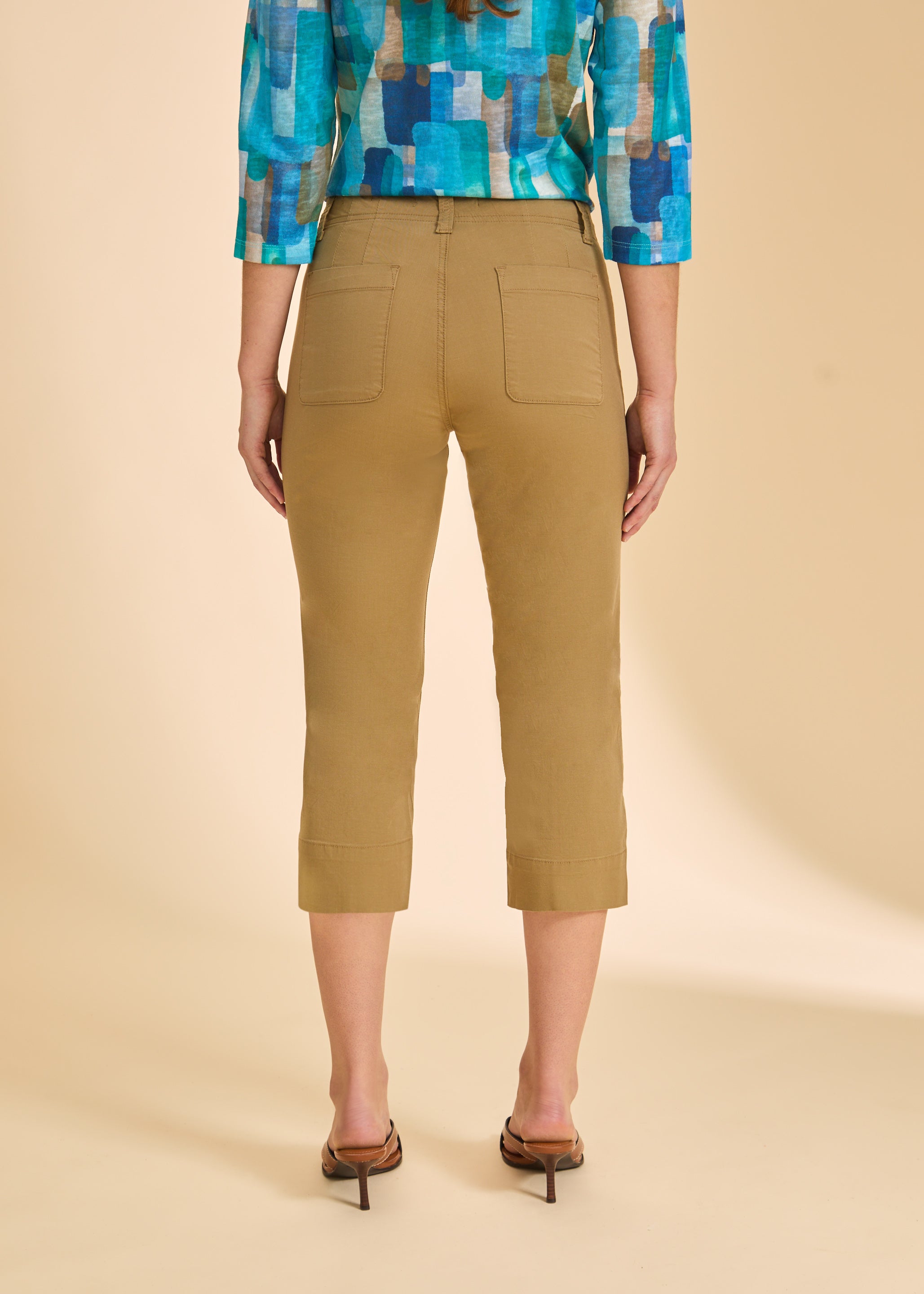 Back view of khaki crop pants featuring patch pockets and slim fit by French Dressing Jeans (FDJ)