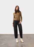 Full view of gold shimmer top paired with black wide-leg pants and white boots by French Dressing Jeans (FDJ)
