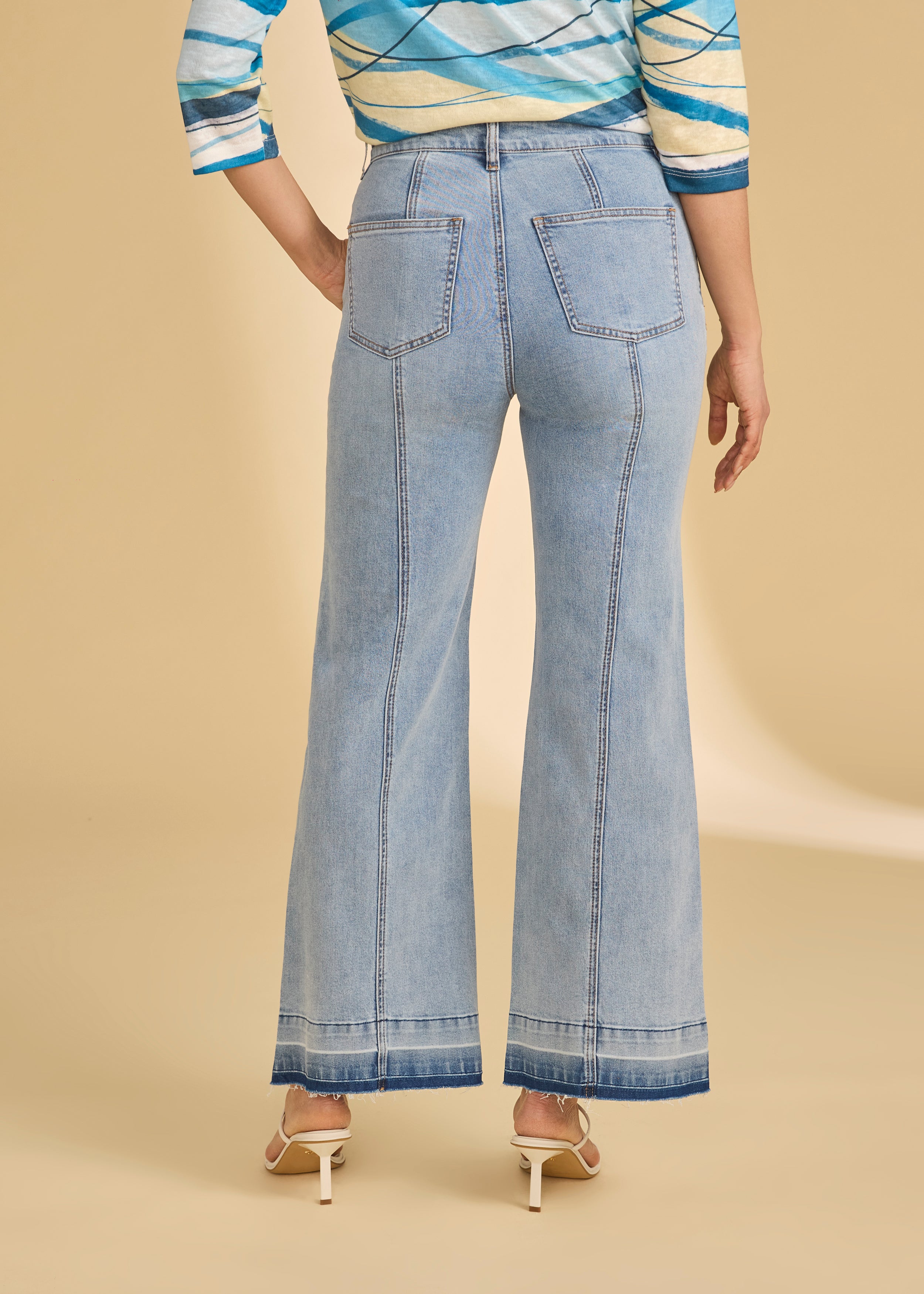 Back view of light metallic lime trousers featuring vertical seams and patch pockets by French Dressing Jeans (FDJ)