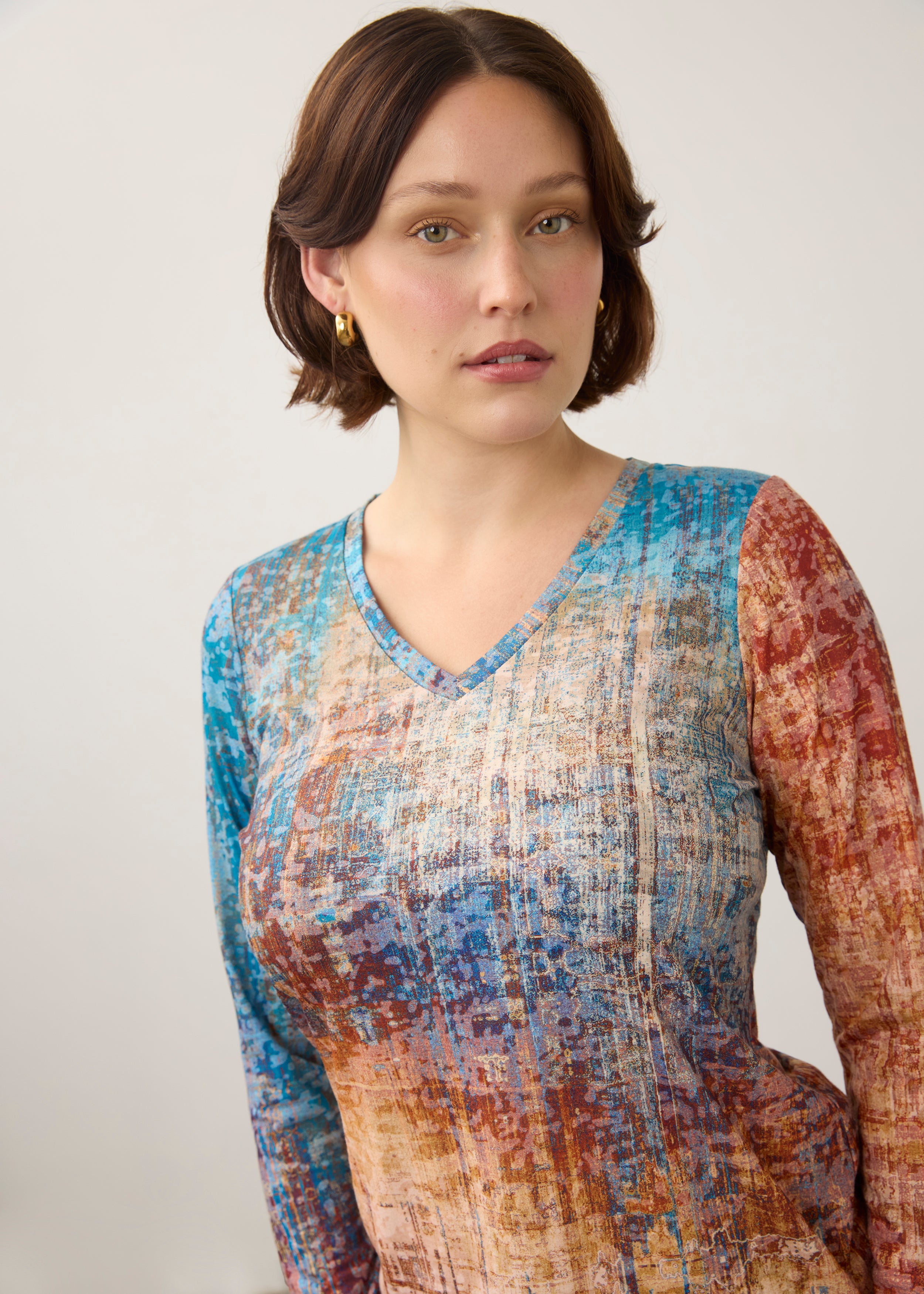 Close-up of V-neck and pattern detail on colorful gradient long sleeve top by French Dressing Jeans (FDJ)