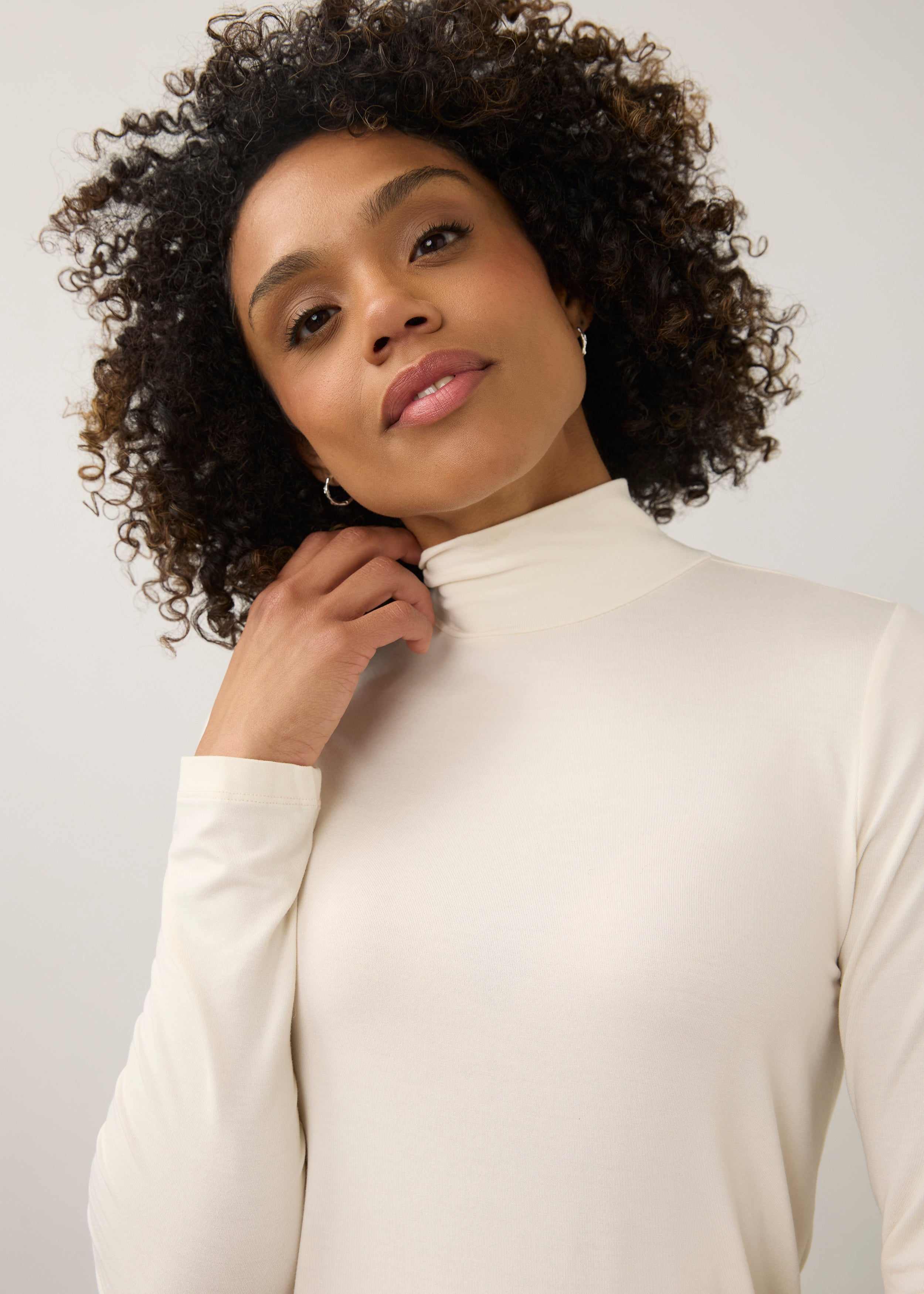Close-up of cream turtleneck top focusing on neckline and soft stretch fabric by French Dressing Jeans (FDJ)