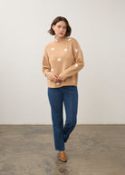 Model in tan polka dot sweater with blue jeans, full outfit view by French Dressing Jeans (FDJ)