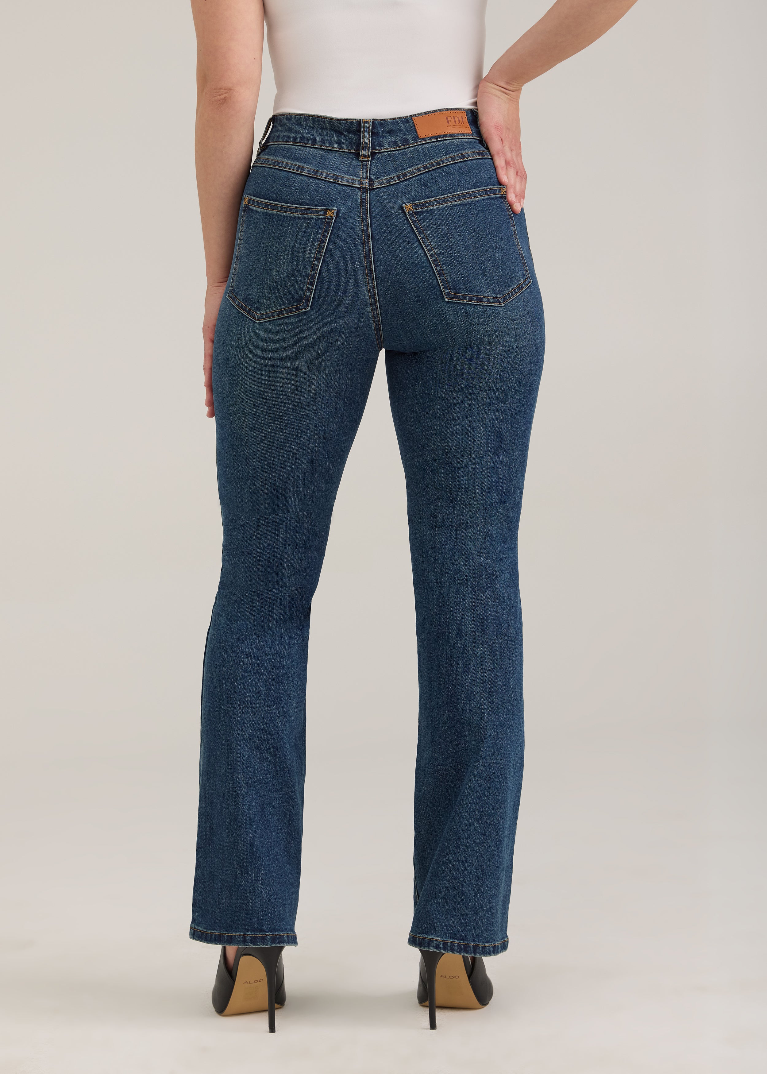Back view of dark wash jeans with high-rise and patch pockets by French Dressing Jeans (FDJ)