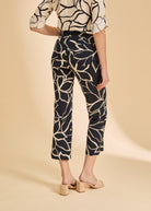 Back view of black plumeria crop pants featuring patch pockets and floral design by French Dressing Jeans (FDJ)
