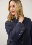 Close-up of navy knit cardigan showing button details and plush texture by French Dressing Jeans (FDJ)