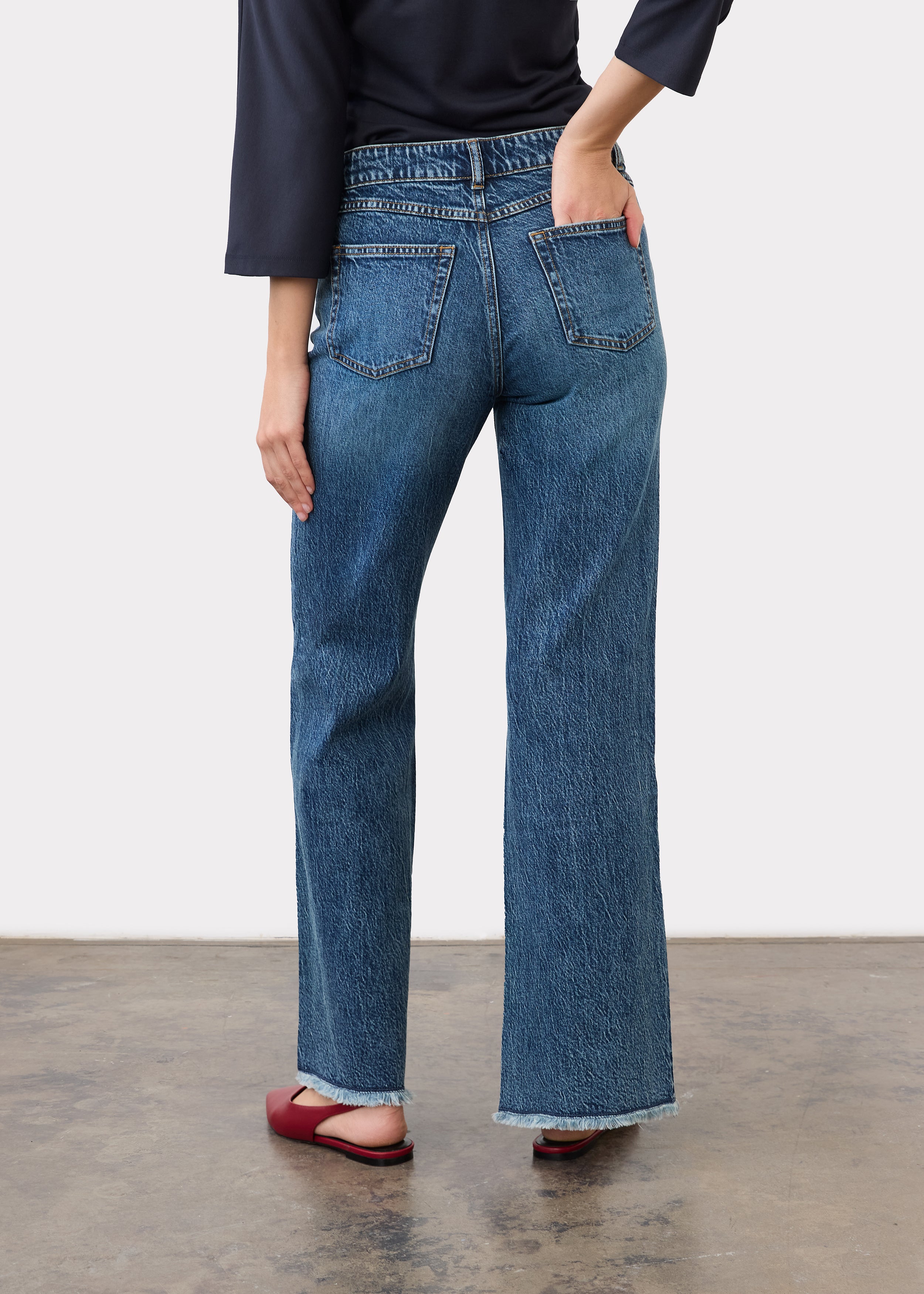 Back view showing patch pockets and bootleg cut in medium blue denim by French Dressing Jeans (FDJ)