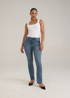 Full view of woman in light wash slim leg jeans with chic fit by French Dressing Jeans (FDJ)