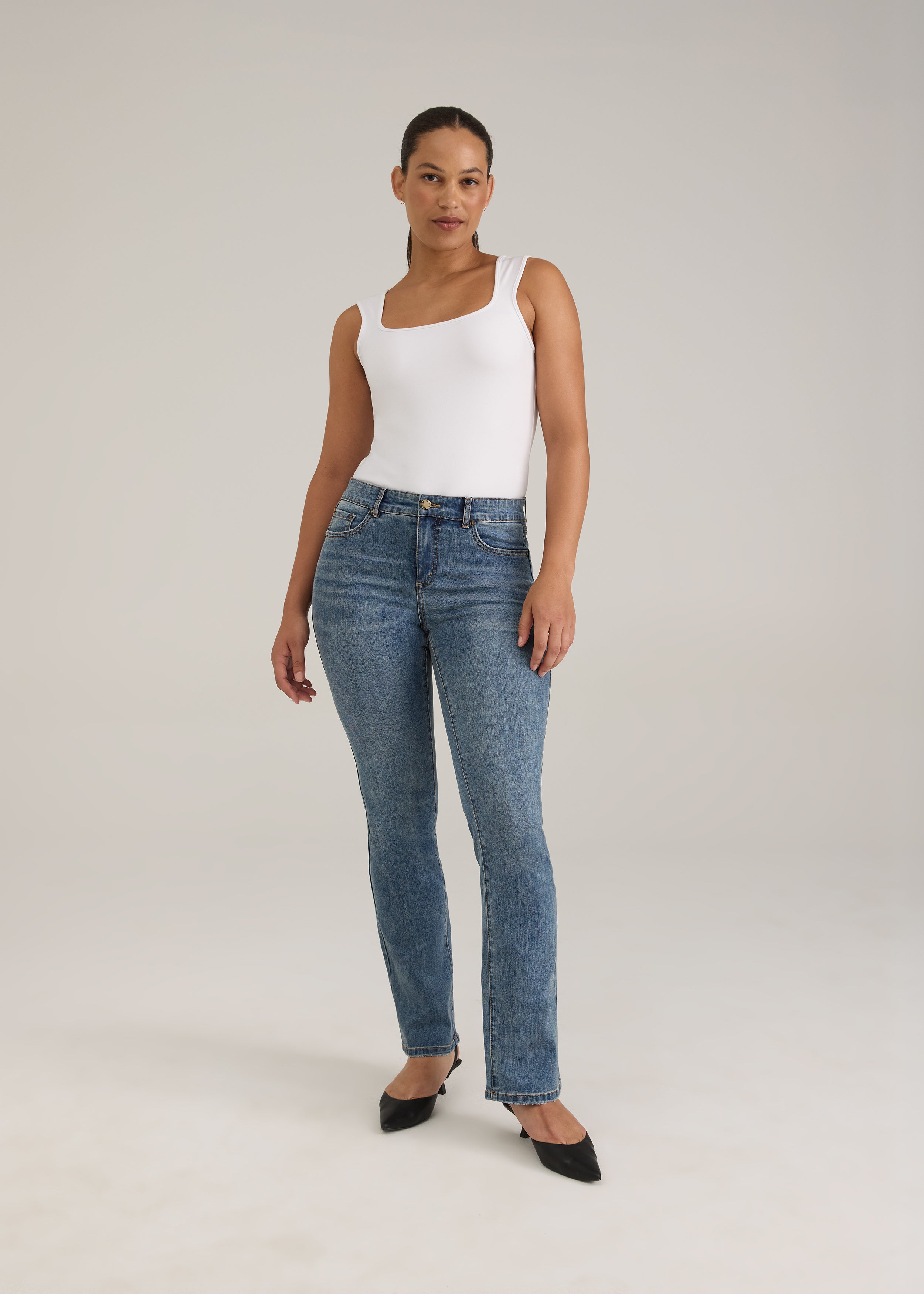 Full view of woman in light wash slim leg jeans with chic fit by French Dressing Jeans (FDJ)