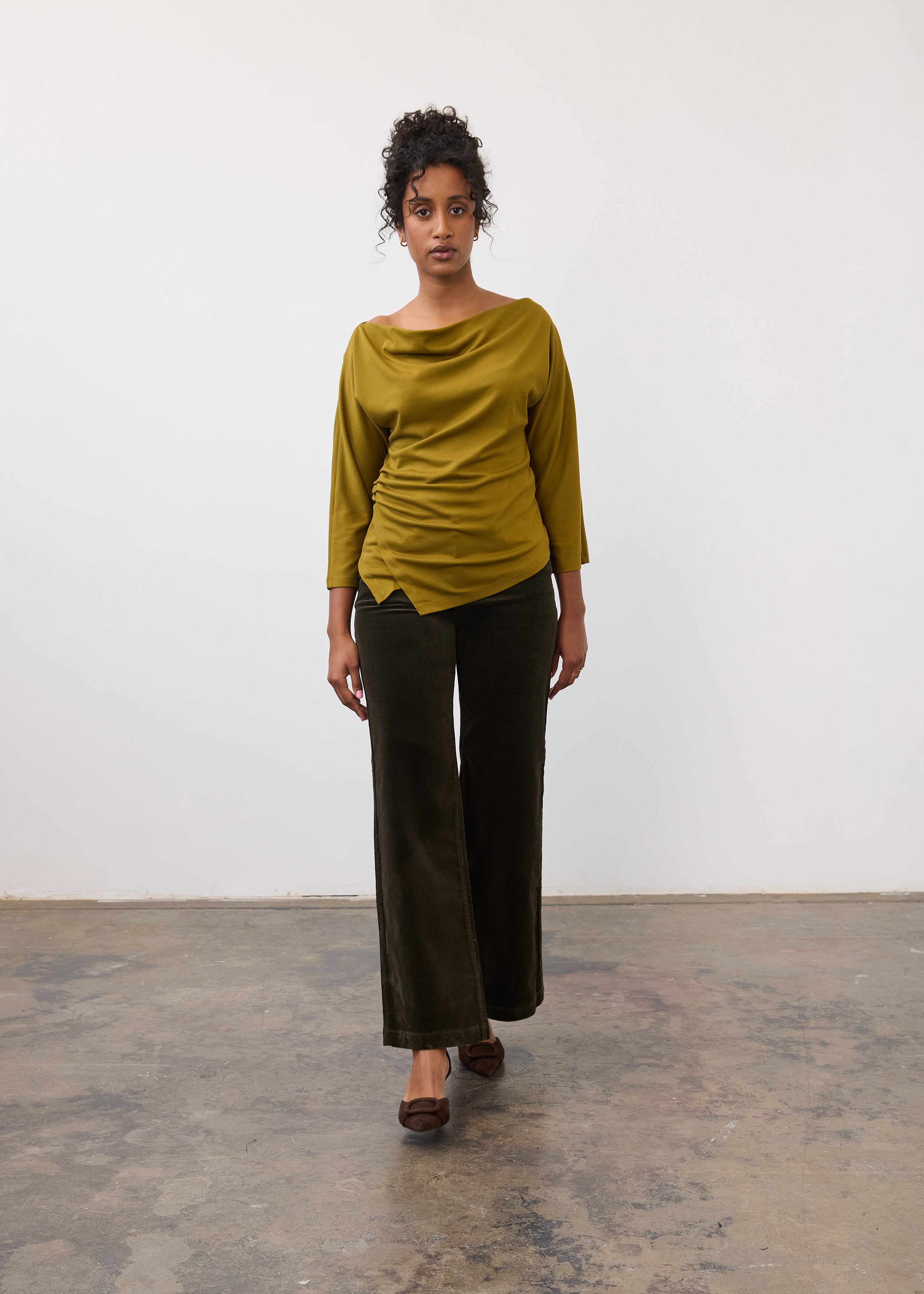 Model wearing olive Olivia wide leg pants with a green top, front view by French Dressing Jeans (FDJ)