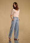 Front view of powder wash high-rise wide leg jeans with hands in pockets by French Dressing Jeans (FDJ)