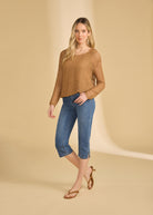 Full body view of darker indigo blue cropped jeans styled with long-sleeve top by French Dressing Jeans (FDJ)