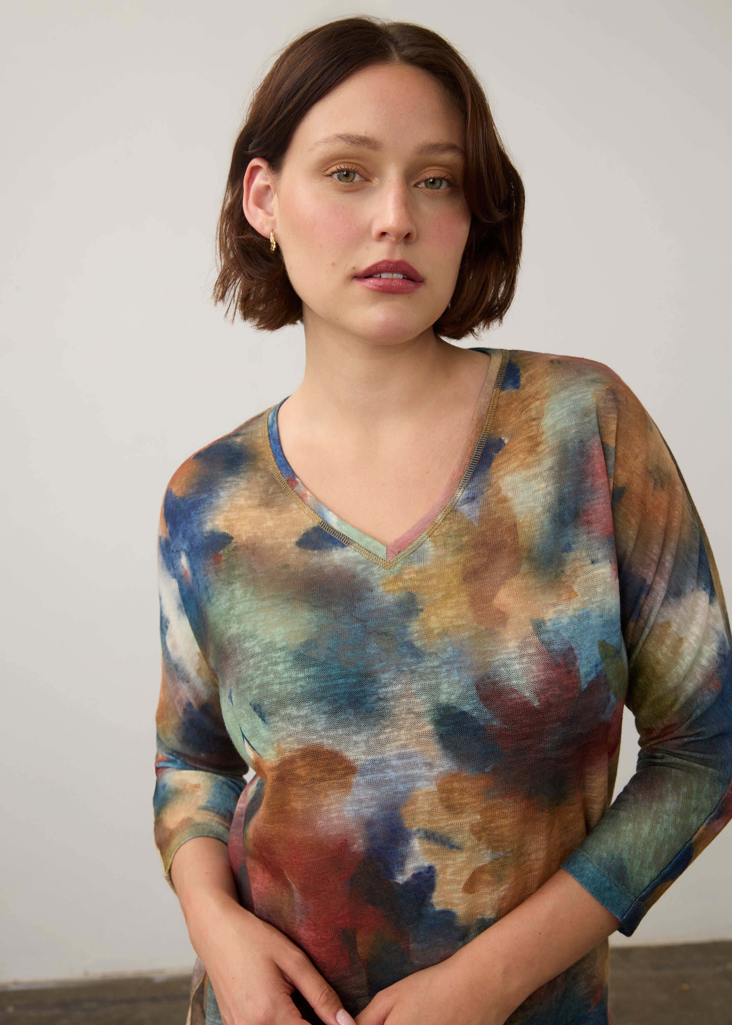 Close-up of watercolor Henley top highlighting V-neck and colorful design by French Dressing Jeans (FDJ)