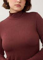 Detail shot of burgundy turtleneck top showing soft texture and fine stitching by French Dressing Jeans (FDJ)
