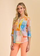 Front view of pastel patchwork 3/4 sleeve top with orange jeans by French Dressing Jeans (FDJ)