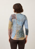 Back view of 3/4 sleeve top showing abstract pattern and rounded hem in Warn color by French Dressing Jeans (FDJ)