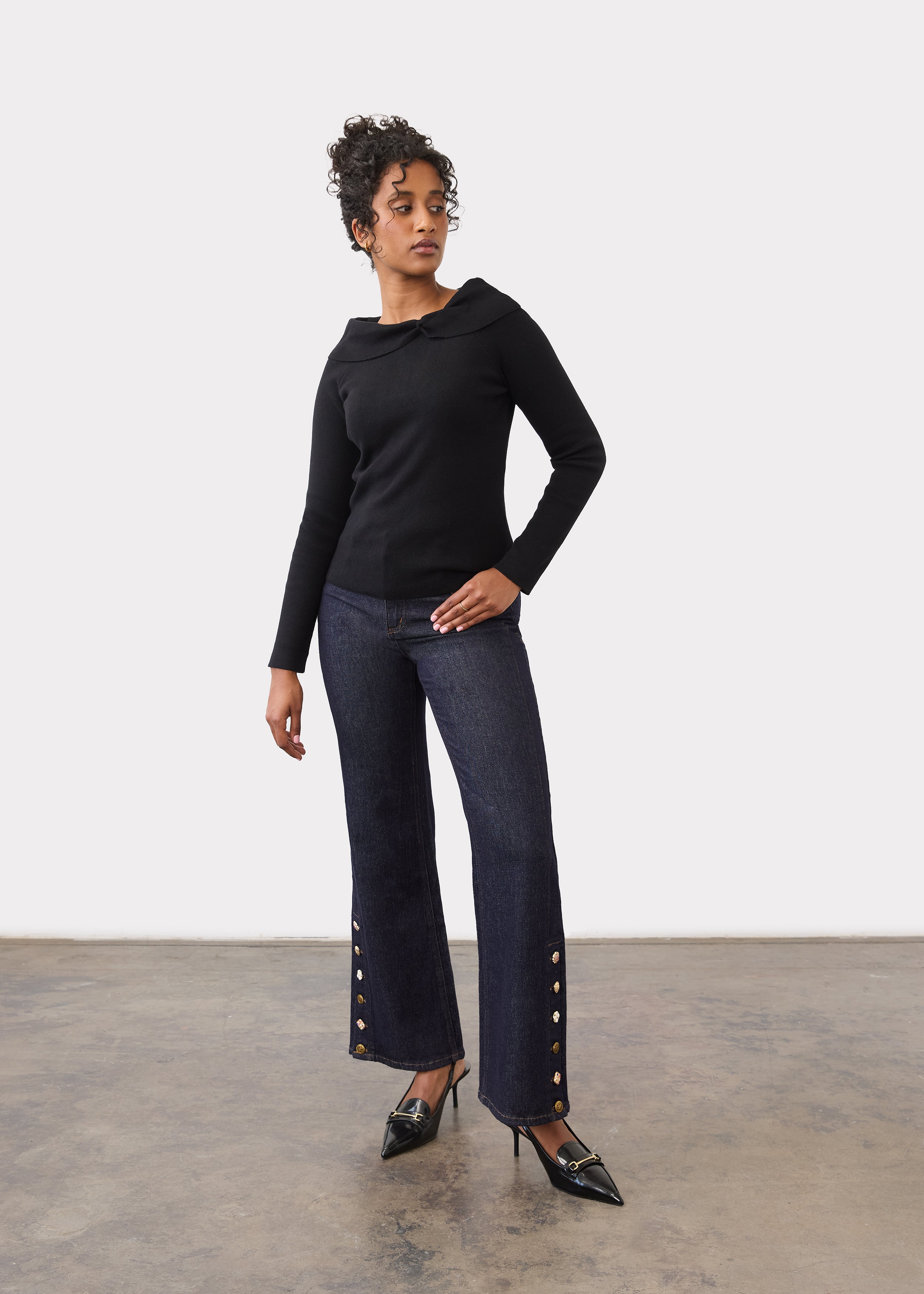 Full body view of black off-the-shoulder sweater styled with jeans by French Dressing Jeans (FDJ)