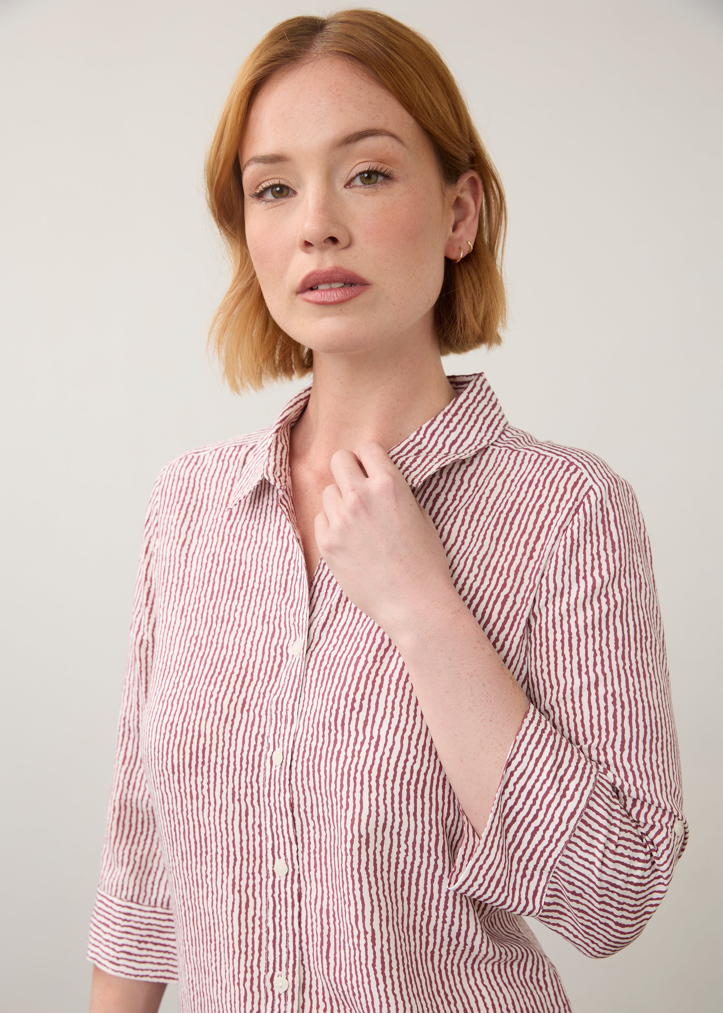 Close-up of striped red and white shirt focusing on button details by French Dressing Jeans (FDJ)