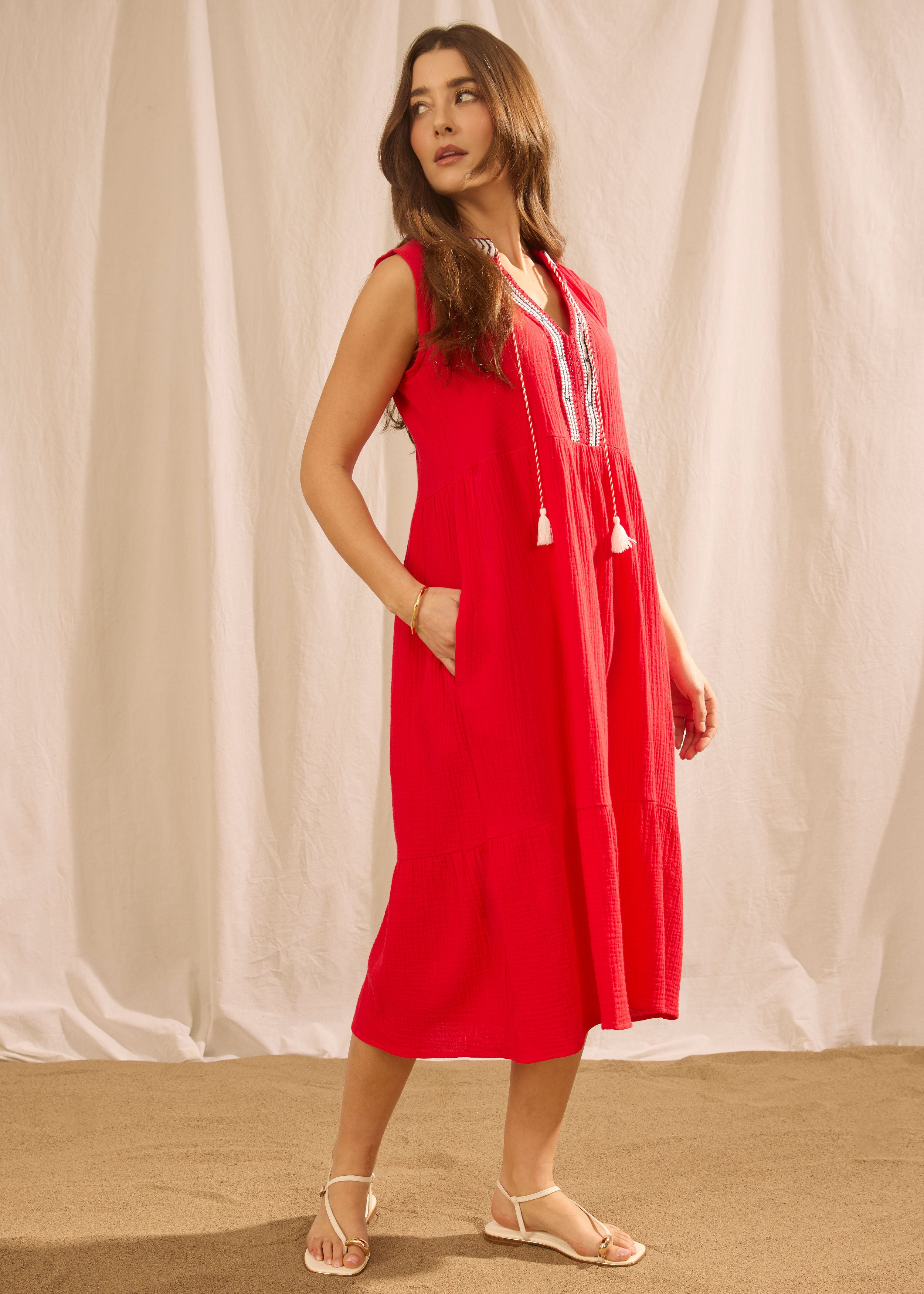 Side view of lava red sleeveless tiered midi dress with side seam pockets by French Dressing Jeans (FDJ)