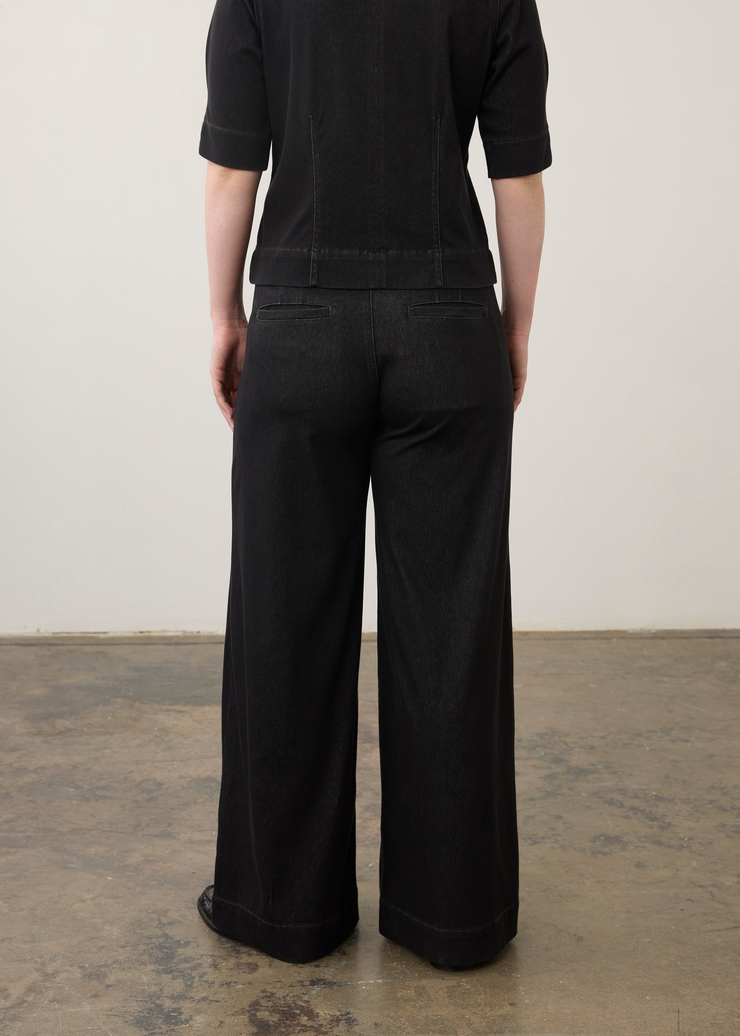 Back view of black wide-leg jeans showcasing welt pockets and seam lines by French Dressing Jeans (FDJ)
