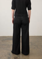 Back view of black wide-leg jeans showcasing welt pockets and seam lines by French Dressing Jeans (FDJ)