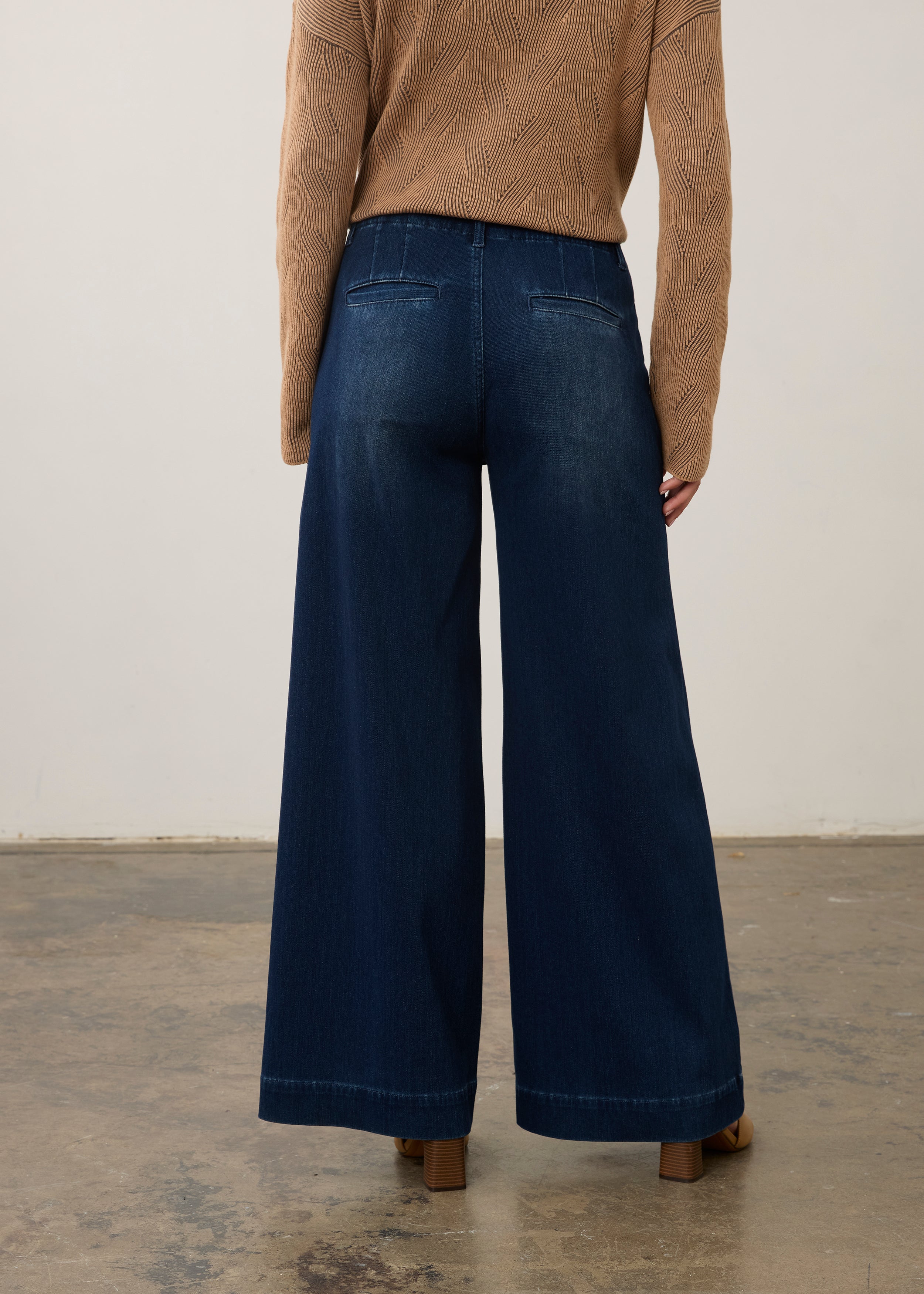 Back view of dark rinse wide-leg jeans highlighting rear pockets and faded finish by French Dressing Jeans (FDJ)