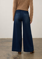Back view of dark rinse wide-leg jeans highlighting rear pockets and faded finish by French Dressing Jeans (FDJ)