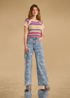 Model wearing multi-color stripe sweater with wide-leg jeans front view by French Dressing Jeans (FDJ)