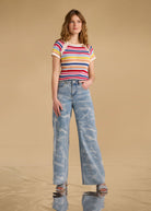 Model wearing multi-color stripe sweater with wide-leg jeans front view by French Dressing Jeans (FDJ)