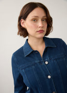 Detail of dark rinse long button-down jacket focusing on button design and collar by French Dressing Jeans (FDJ)