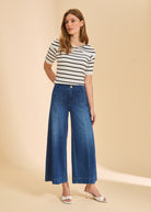 Front view of striped top paired with dark blue wide-leg denim pants by French Dressing Jeans (FDJ)