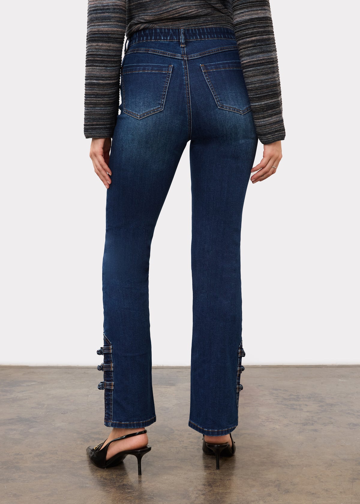 Back view of dark blue denim featuring back patch pockets and button accents by French Dressing Jeans (FDJ)