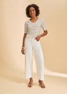 Full outfit with beige striped V-neck top and white pants highlighting neutral tones by French Dressing Jeans (FDJ)