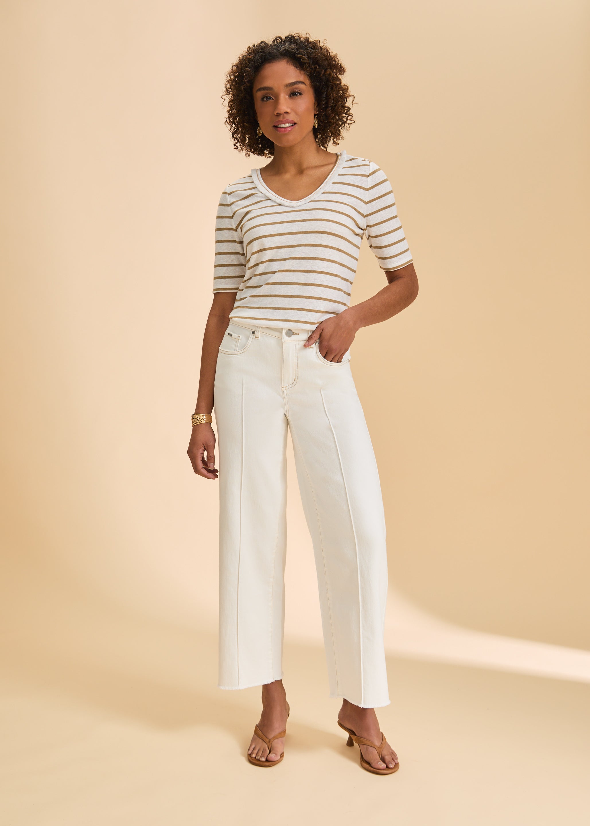Full outfit with beige striped V-neck top and white pants highlighting neutral tones by French Dressing Jeans (FDJ)