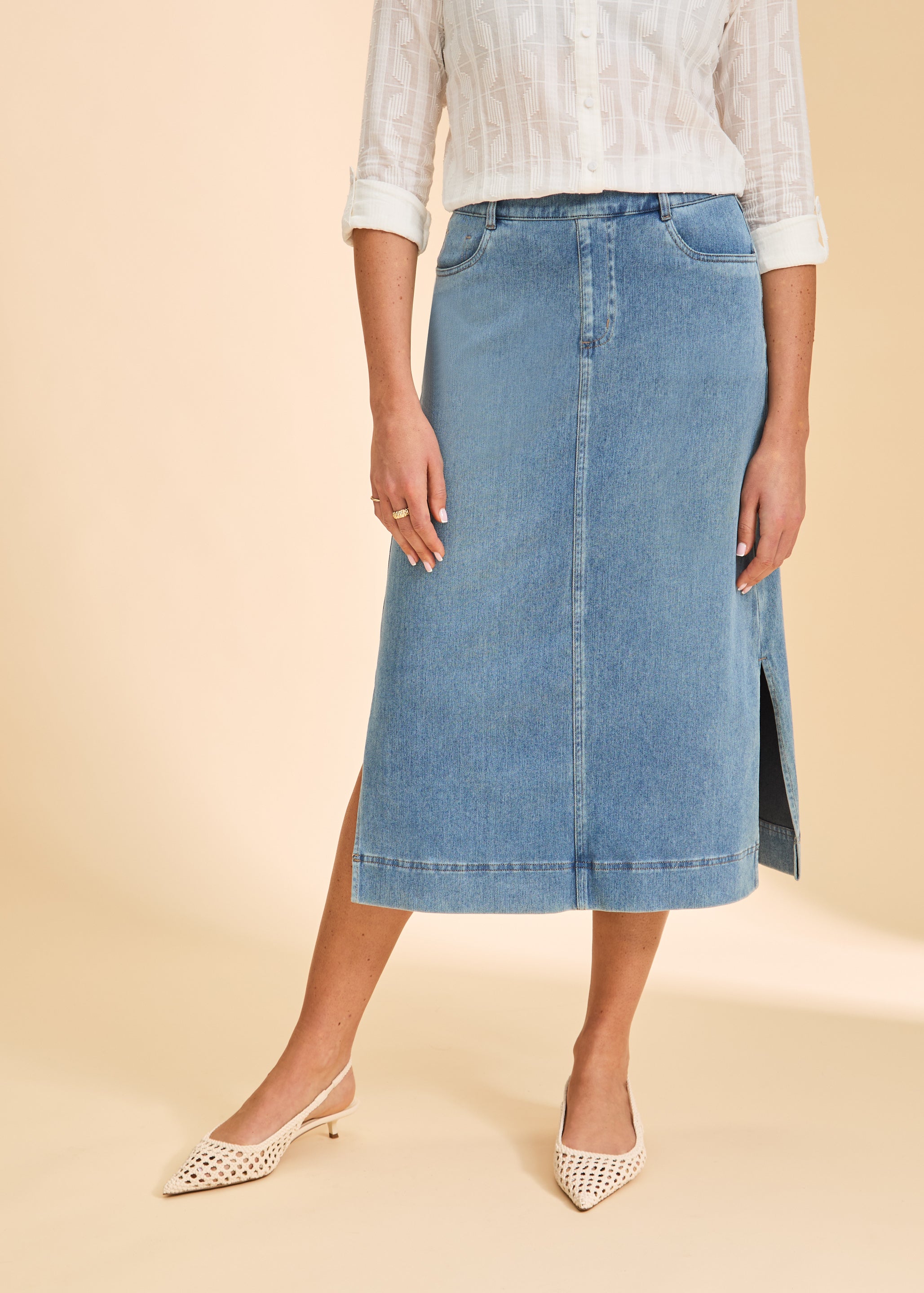 Close-up of light blue denim skirt showing front pockets and side slit by French Dressing Jeans (FDJ)