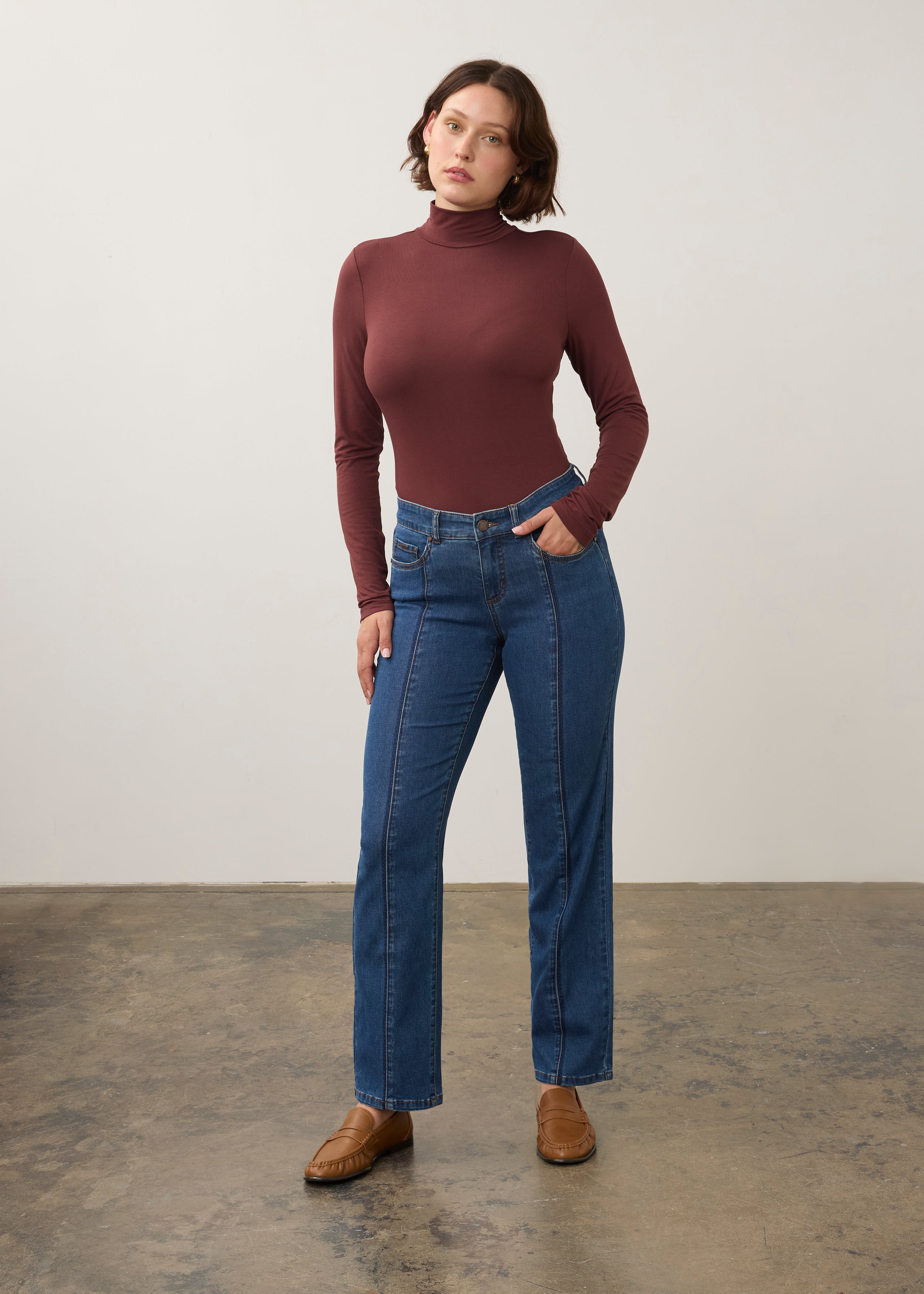 Full body view of burgundy turtleneck top styled with jeans for a modern look by French Dressing Jeans (FDJ)