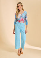 Full outfit view with blue floral top and light blue pants, highlighting scoop neck design by French Dressing Jeans (FDJ)