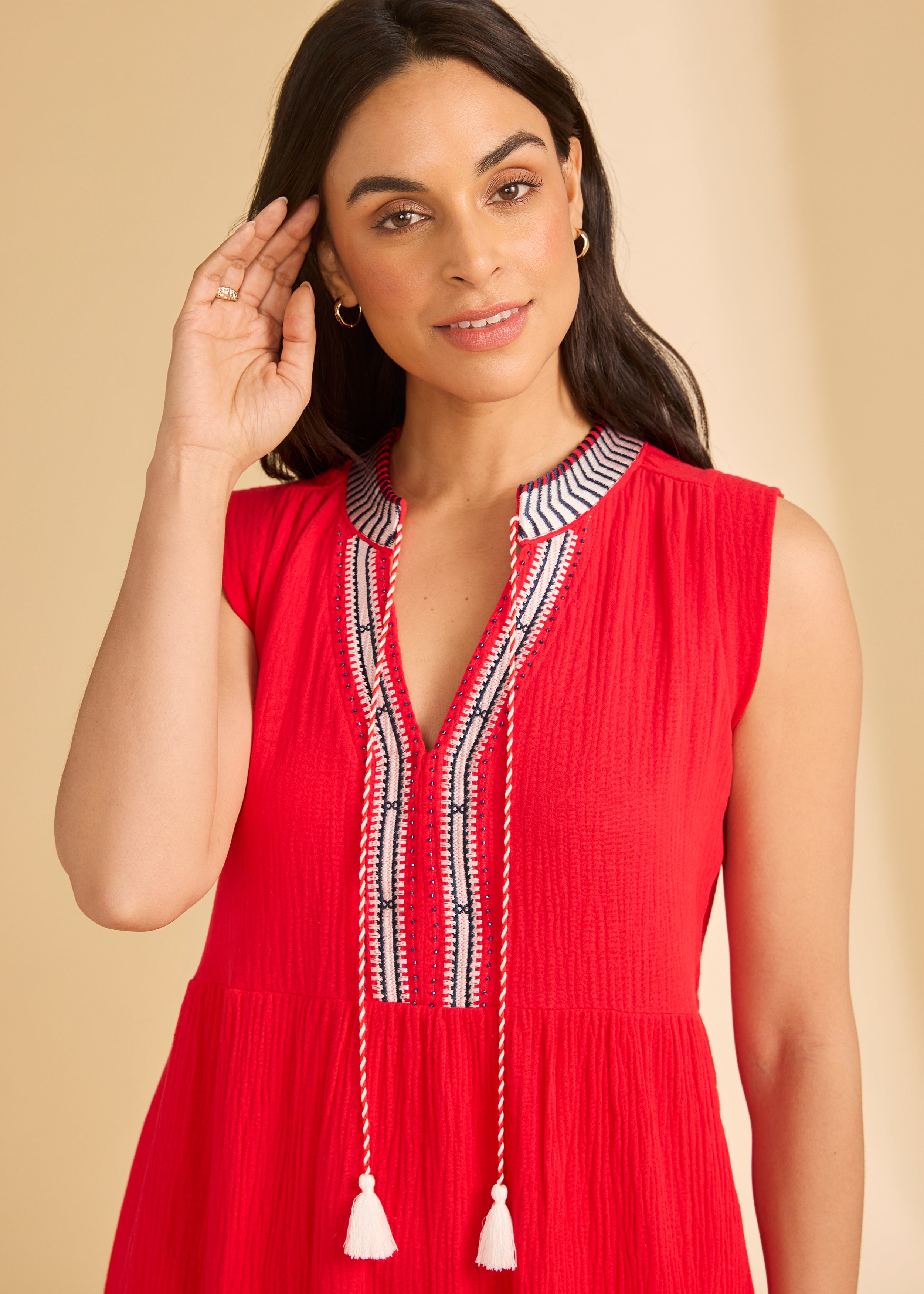 Close-up of V-neckline detail on lava red sleeveless dress with tassel ties by French Dressing Jeans (FDJ)
