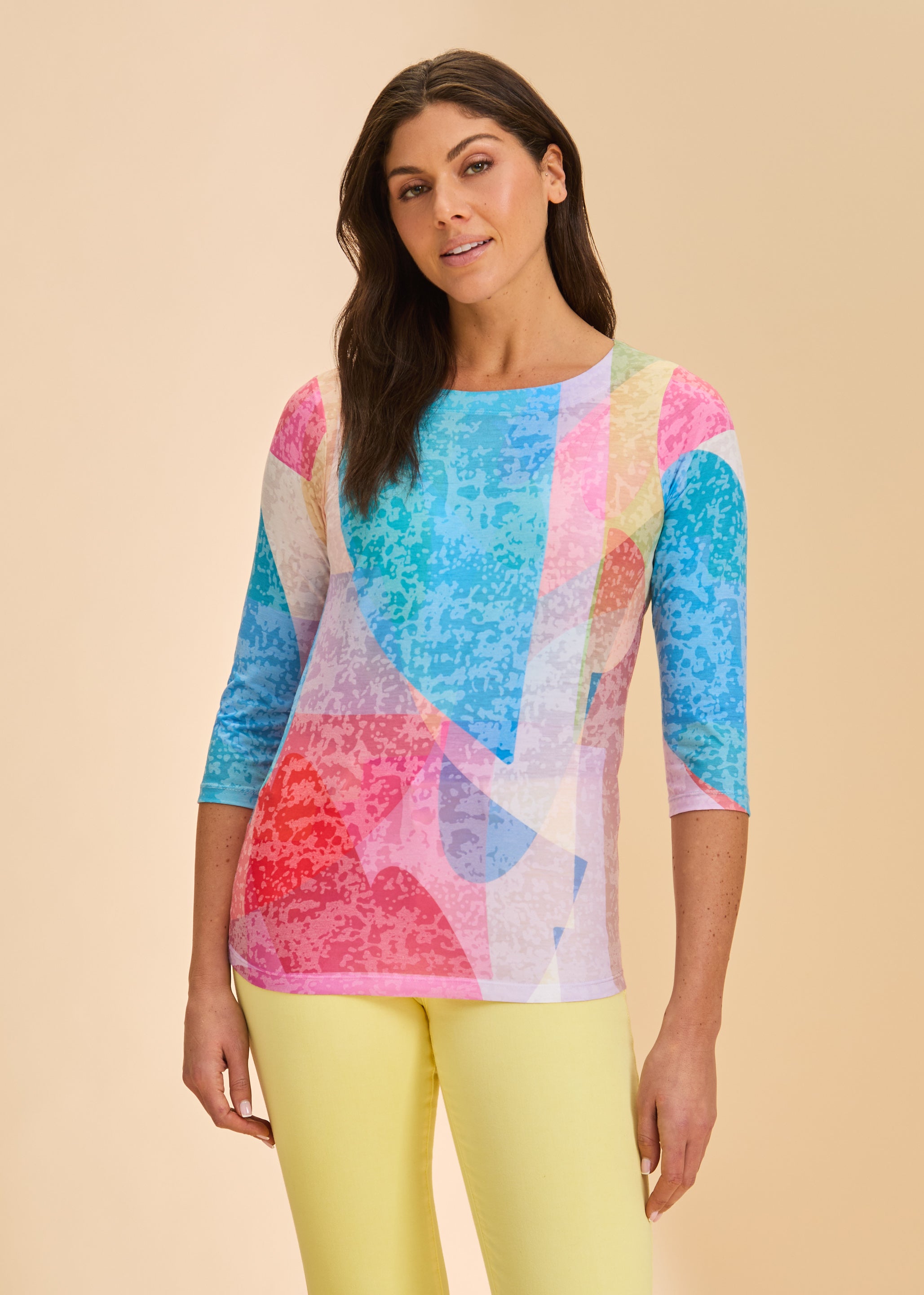 Front view of colorful geometric top with 3/4 sleeves and scoop neck paired with yellow pants by French Dressing Jeans (FDJ)