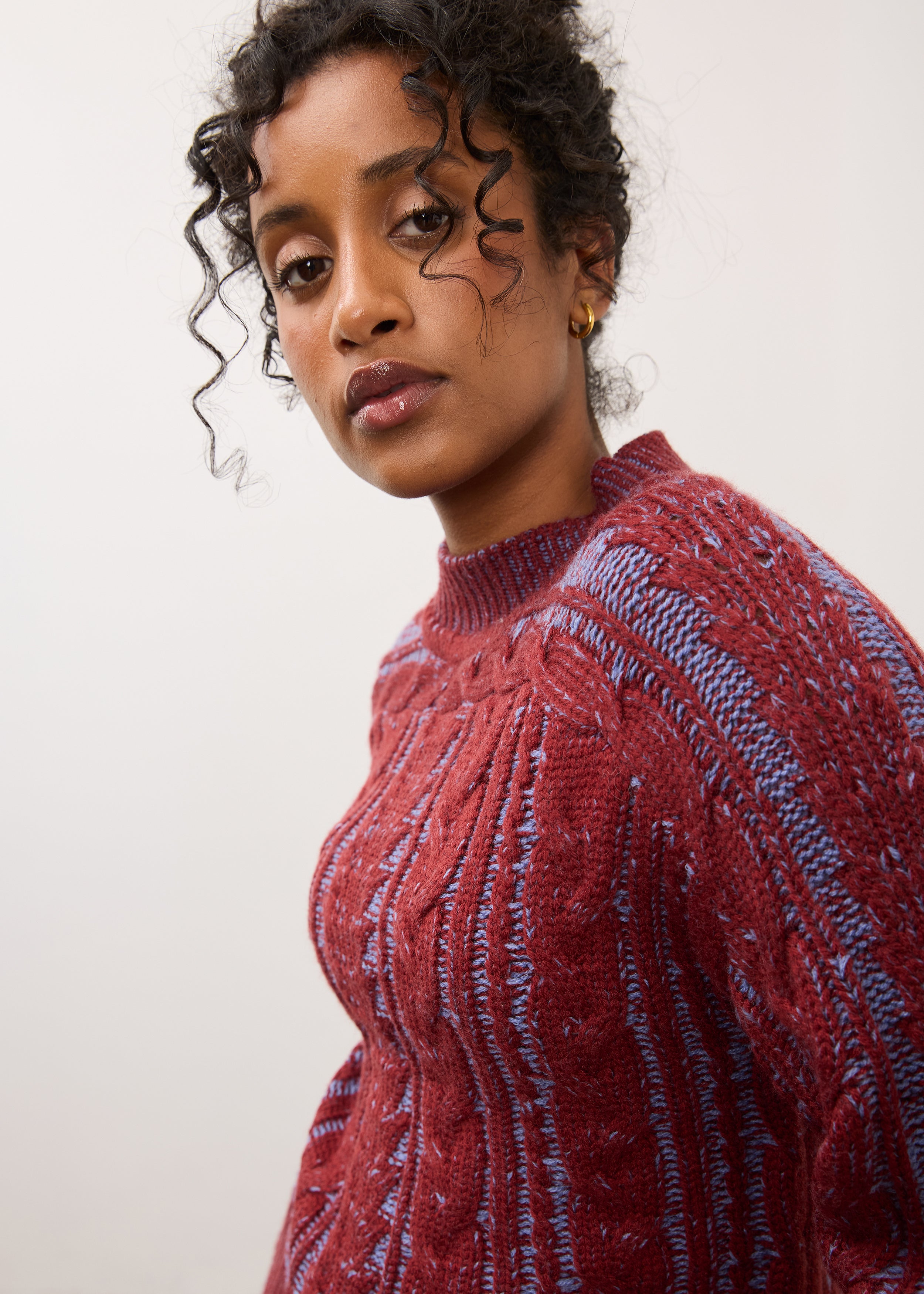 Close-up of maroon cabled sweater focusing on texture and knit pattern by French Dressing Jeans (FDJ)