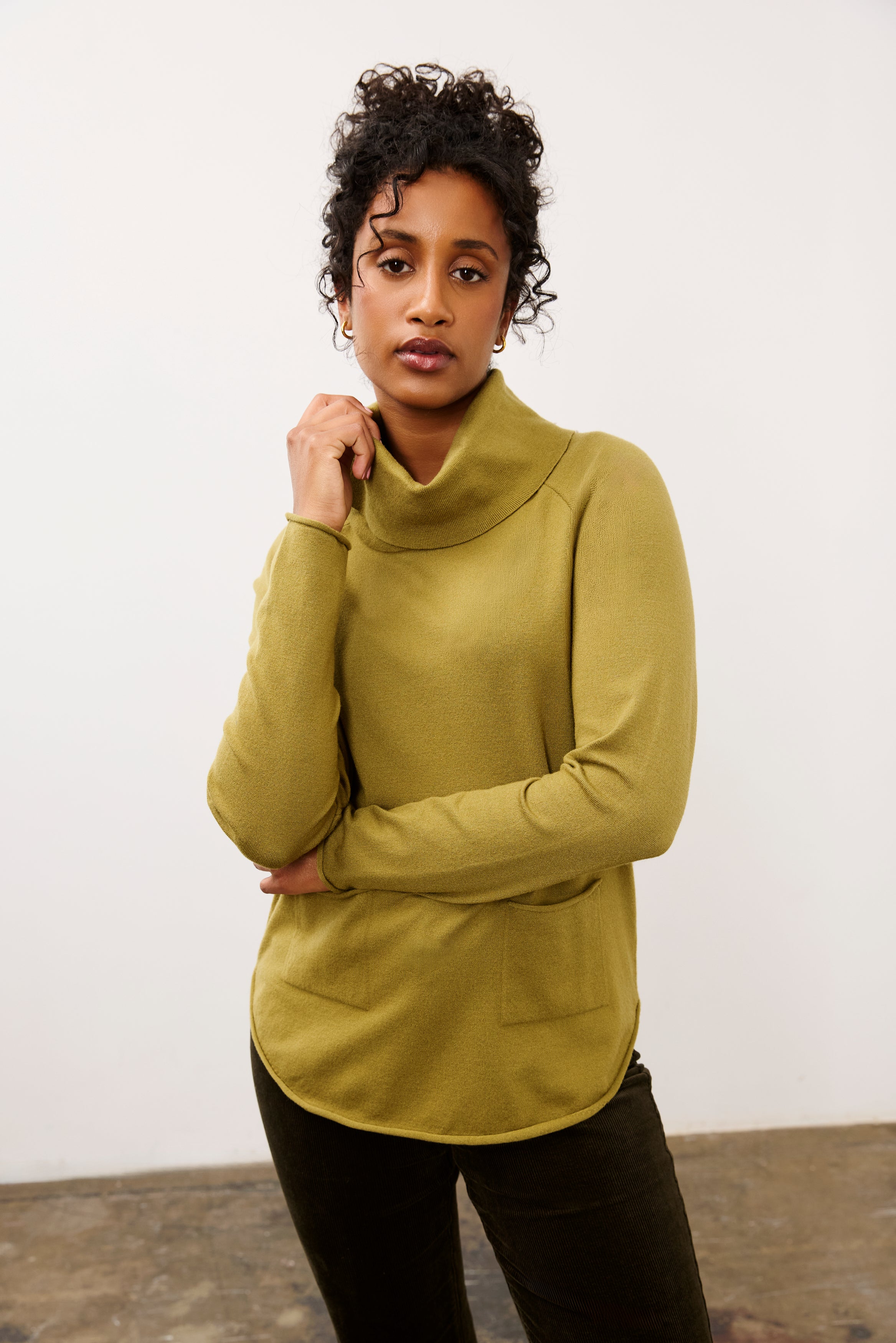 Front view of olive sweater with cowl neck and front pockets by French Dressing Jeans (FDJ)