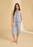 Model wearing sleeveless denim top with powder wash shorts in studio setting by French Dressing Jeans (FDJ)