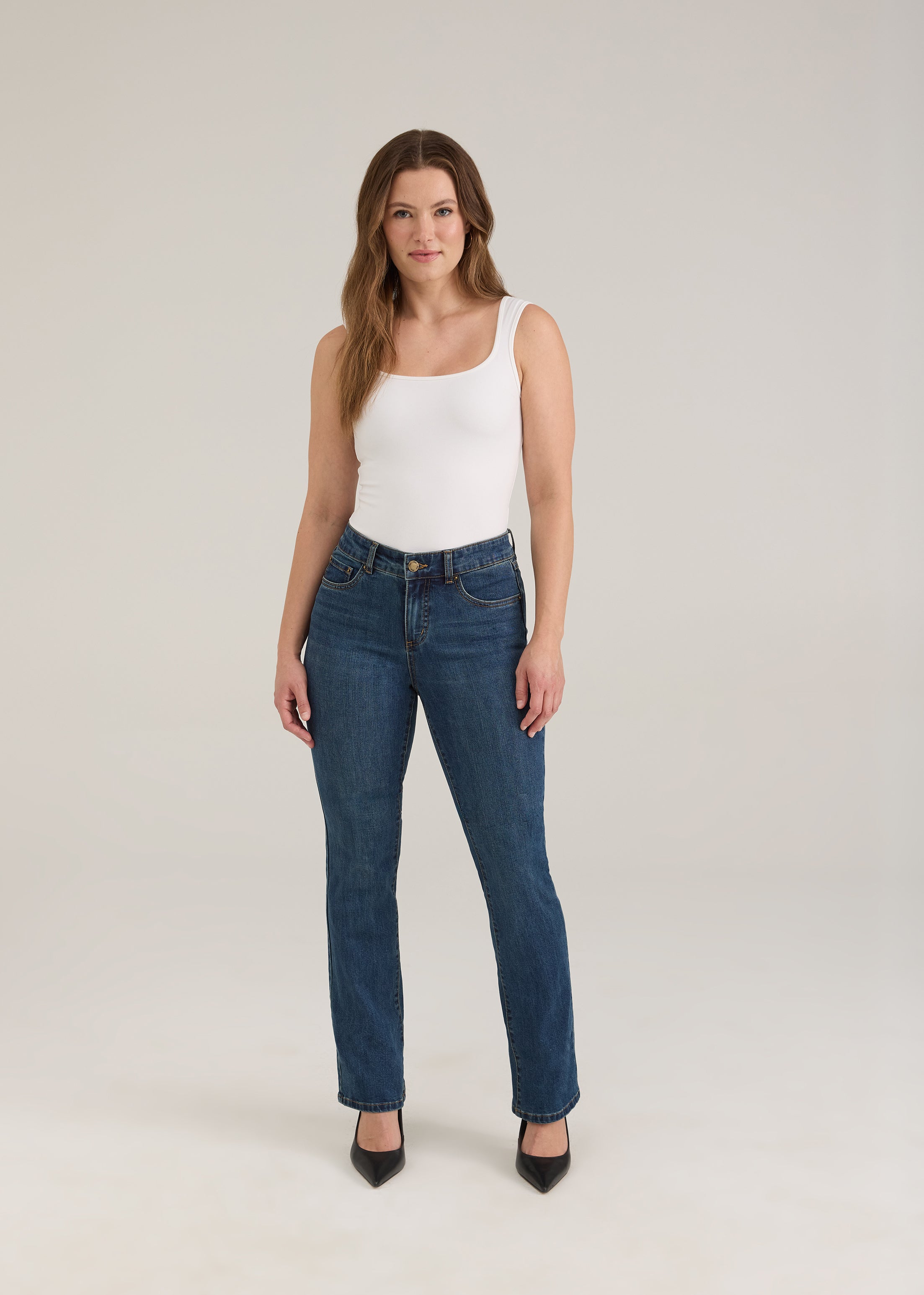 Full body view of woman in dark wash slim leg jeans with sleek fit by French Dressing Jeans (FDJ)