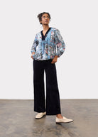 Model wearing black Olivia wide leg pants with a colorful blouse, front view by French Dressing Jeans (FDJ)