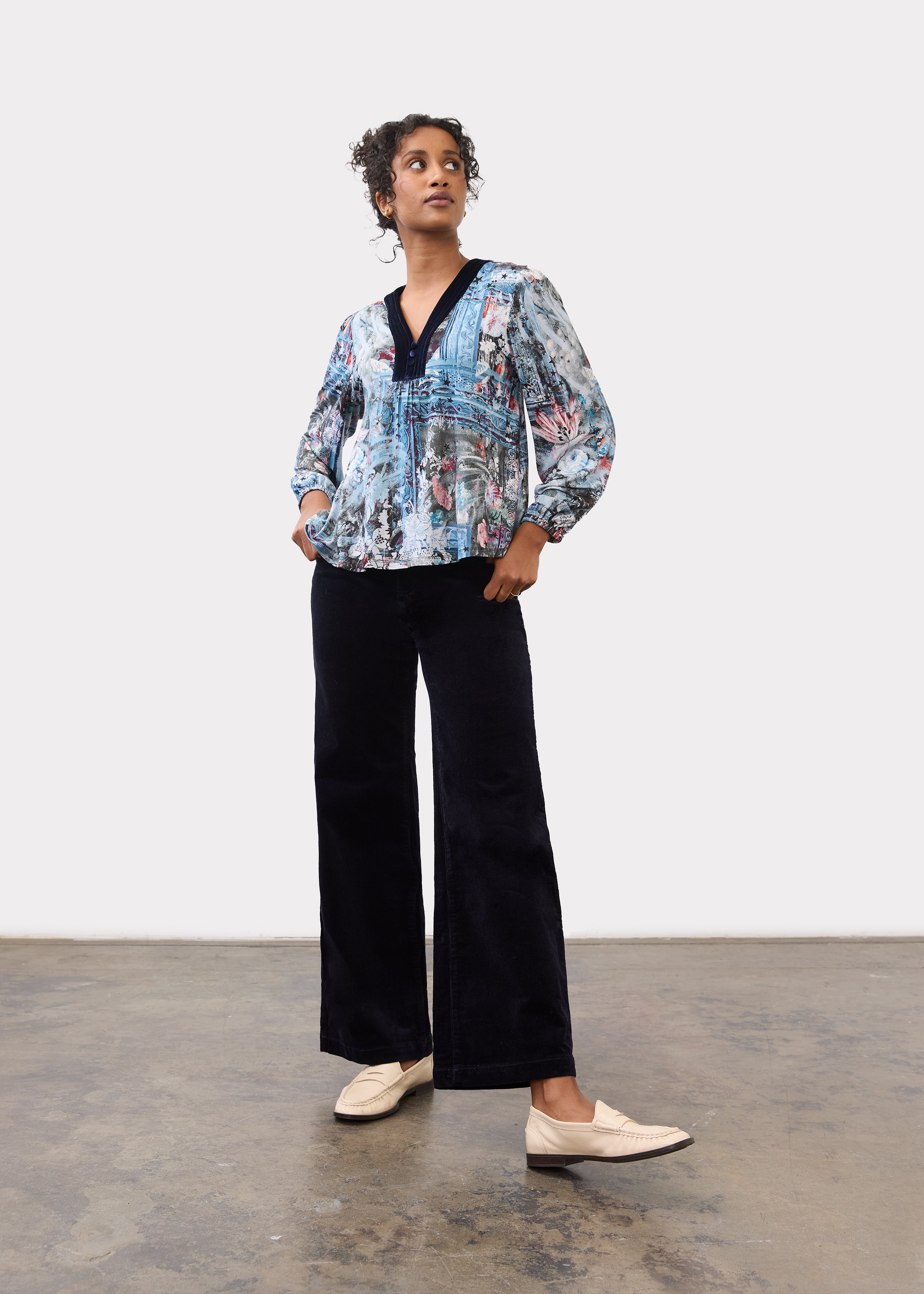 Model wearing black Olivia wide leg pants with a colorful blouse, front view by French Dressing Jeans (FDJ)